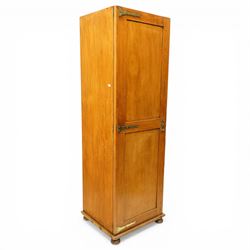 Late 19th century Arts & Crafts stained pine single hall wardrobe, single panelled door with brass fittings enclosing sliding tray to top with hanging rail and hooks, hinged box seat to base, on compressed bun feet