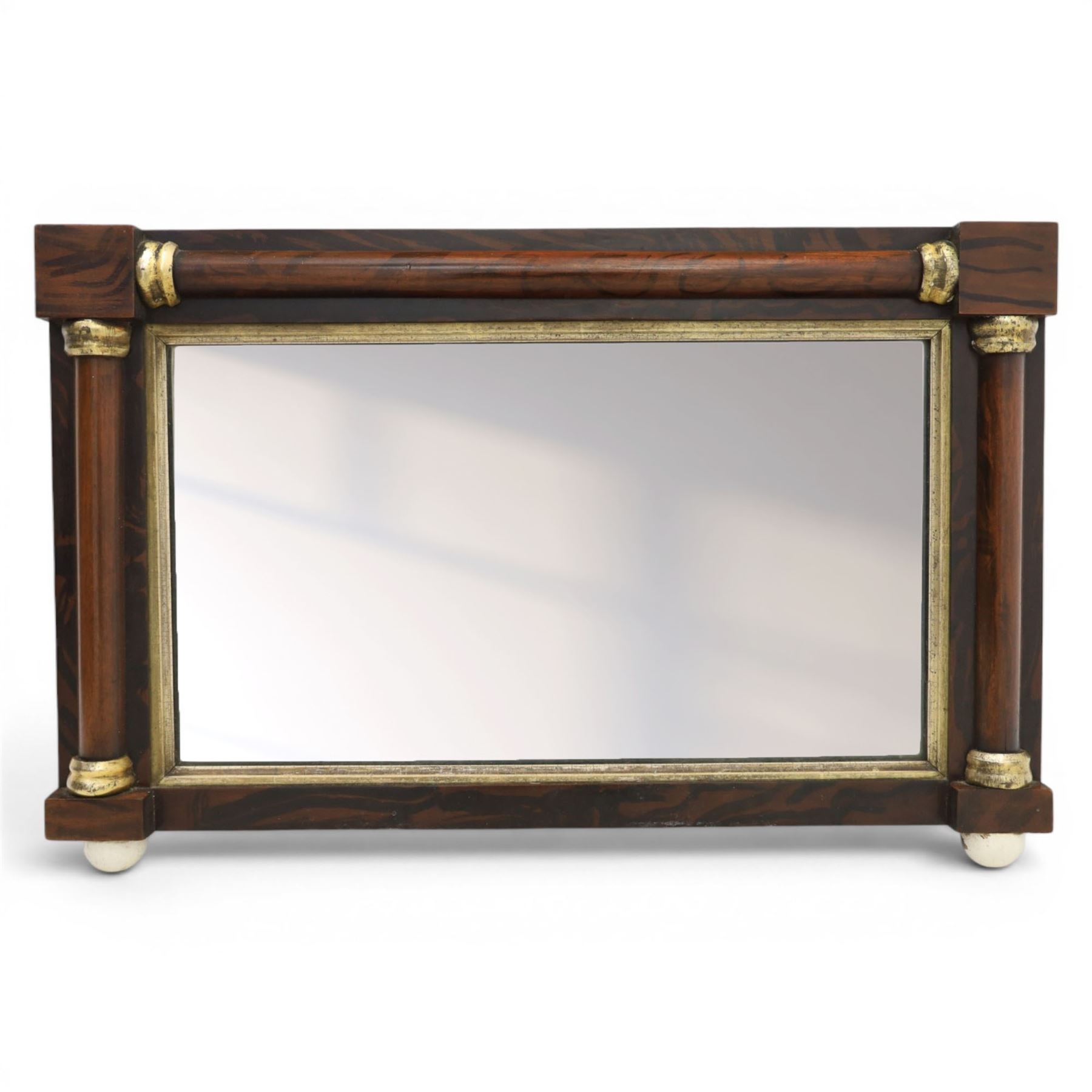 19th century brass and simulated rosewood mirror, with ceramic finials