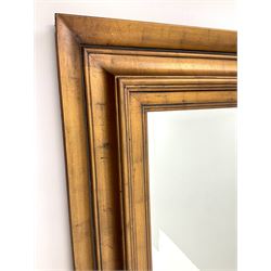 Large rectangular swept gilt framed bevel edge mirror 