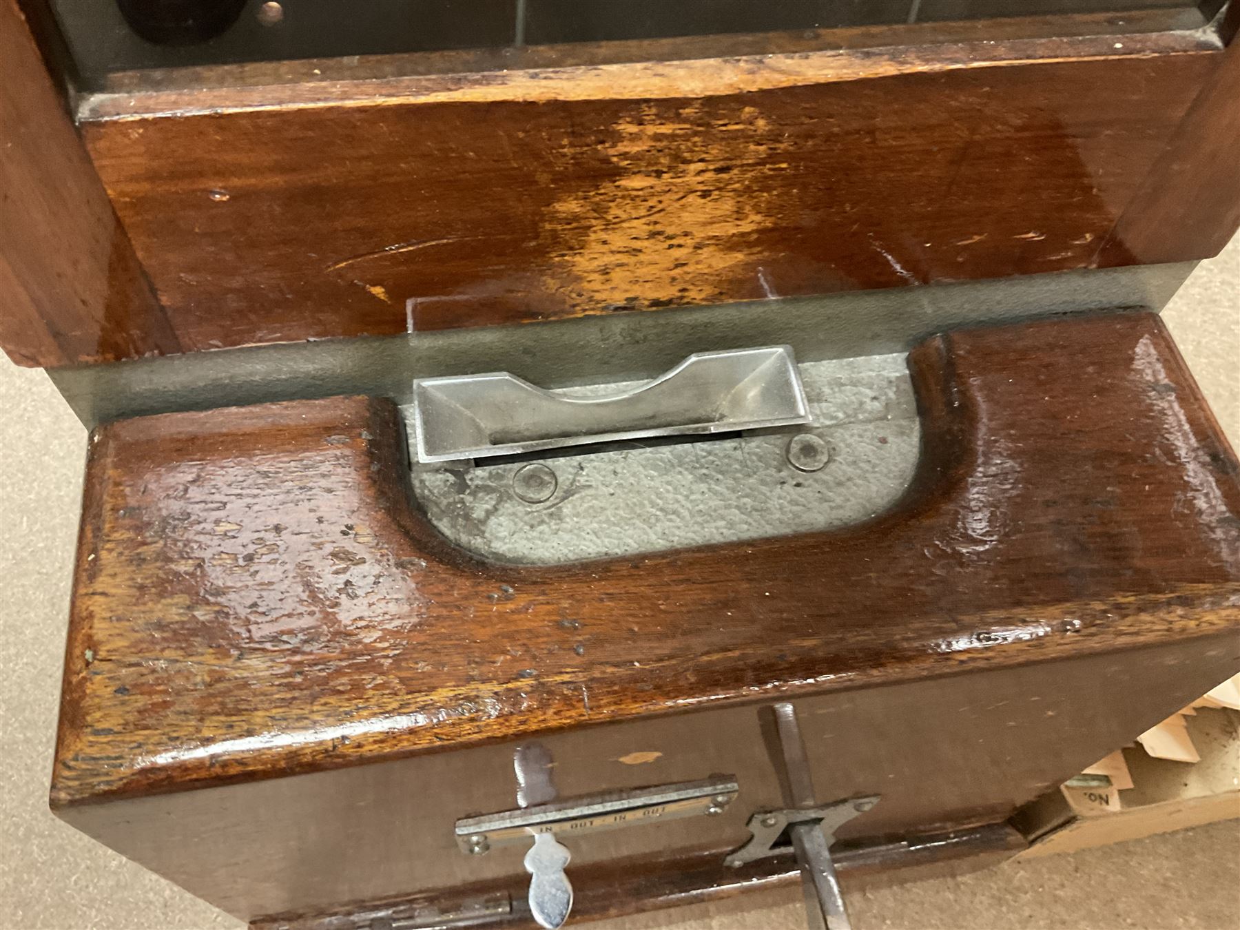Early 20th Century Time Recorders Leeds Ltd mahogany cased clocking in machine, the square silvered dial with Arabic numerals above clocking in mechanism on plinth base, with a collection of blank clocking in cards, case H98cm