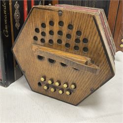 Three European concertinas, comprising Viceroy German concertina with 21 keys, hexagon wooden frame and 8 fold bellows
Oak framed concertina with 12 keys and 8 fold bellows
Commander concertina with 12 keys and 12 fold bellows
With tutor
