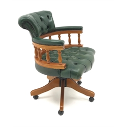  Captain's swivel chair upholstered in green buttoned leather on swivel base, W62cm  
