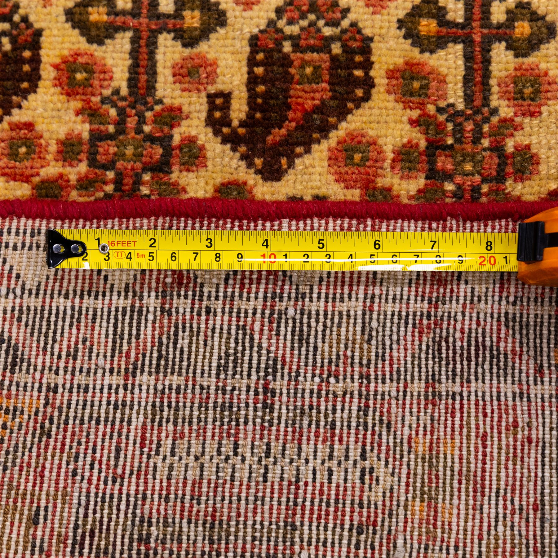 North West Persian Malayer hand-knotted rug, ivory field with central stepped lozenge medallion with angular pendants, surrounded by rows of stylized boteh and geometric floral devices within multiple geometric and stylized vine borders, with fringe ends