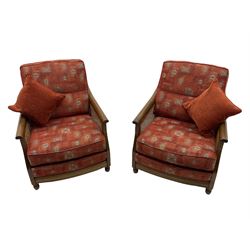 Ercol medium elm framed three seat bergere sofa, and pair of matching armchairs upholstered in red fabric