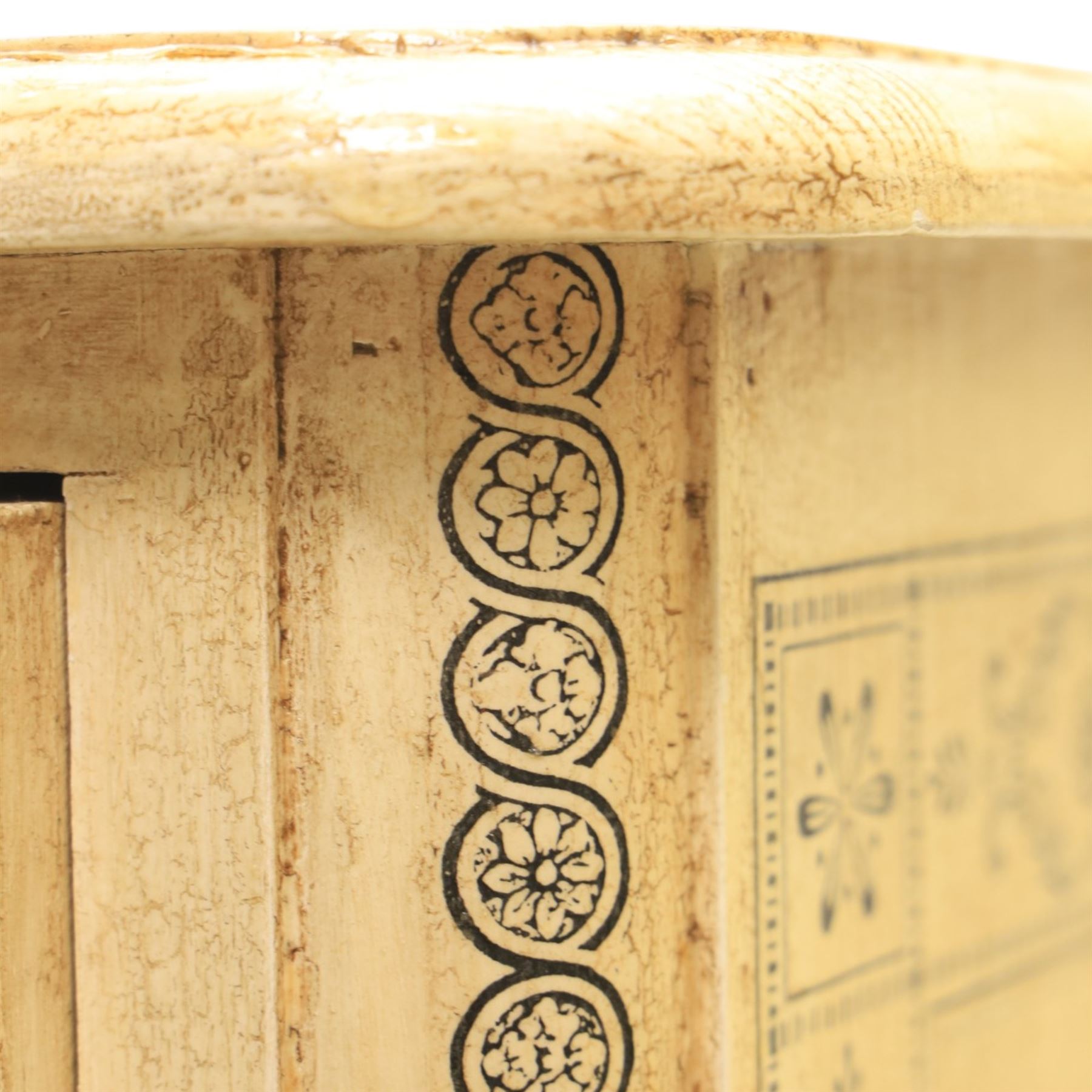 Traditional design cream painted lacquered pedestal chest, rounded moulded top over four short drawers, the drawer fronts decorated with monochrome printed animal scenes, conforming foliate and geometric borders to the top and sides, turned handles, on bun feet