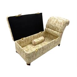 Late 20th century chaise longue ottoman, upholstered in fabric decorated with garden courting scenes, reclining back with staggered mechanism, double hinged and removable upholstered seat revealing storage, with bolster cushion, on compressed turned feet with recessed castors 