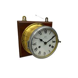 A compact German manufactured ships clock in a spun brass case with a 5