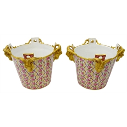  Late 19th/ early 20th century pair Serves style porcelain ice pails, probably Samson, the tapered bodies hand painted with trailing roses and ribbon with four ram mask heads in gilt, H21cm (2)  