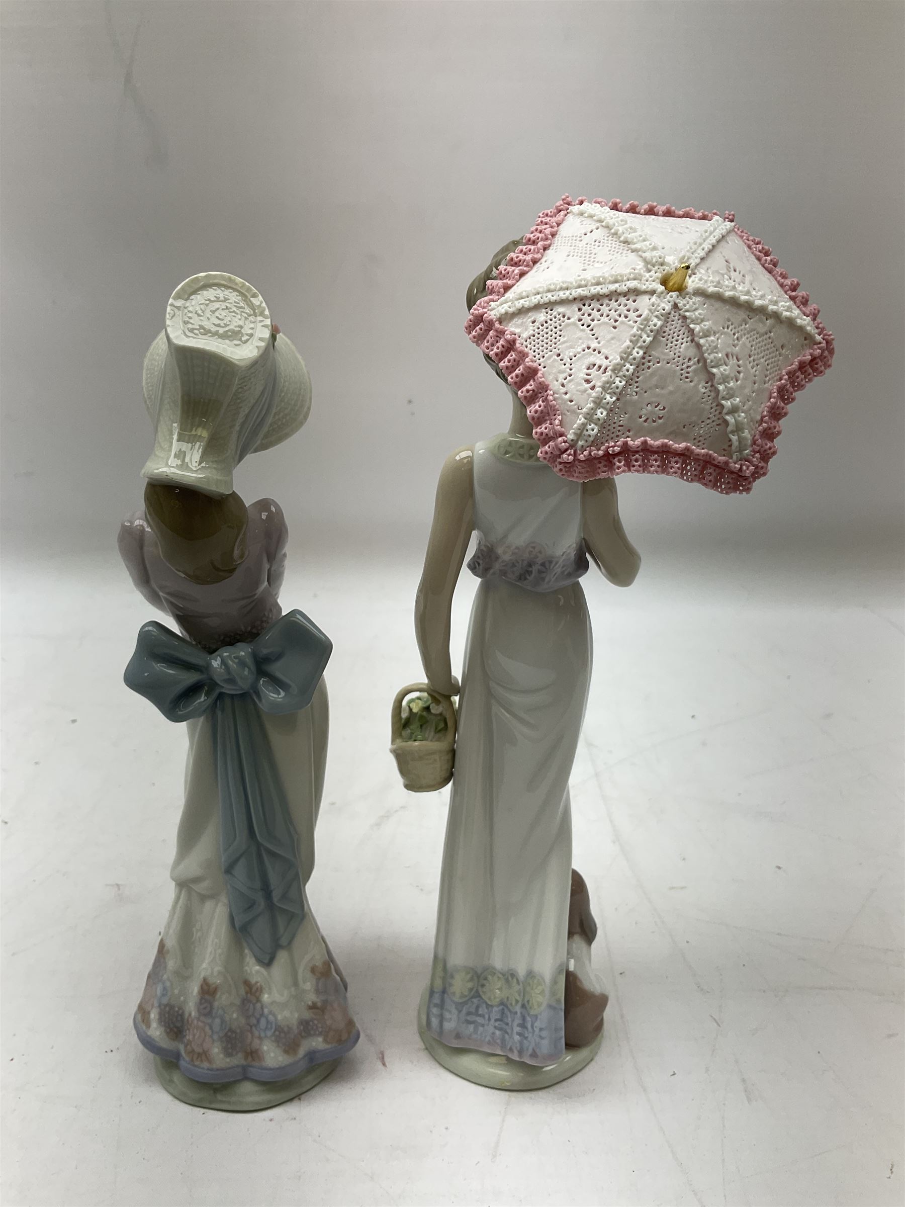Two Lladro figures, comprising Garden Classic, no 7617 and Garden Song, no 7618, with original boxes and artists signature beneath, largest example H23cm