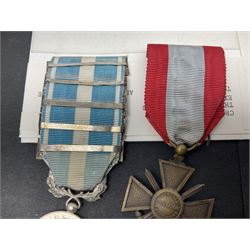French Republic Colonial Medal with five clasps for Libye, Afrique Francaise Libre, Bir Hakeim, Koufra and Tchad; and Croix de Guerre Des Theatres D'Operations Exterieurs with three MID leaves and gold star; both with ribbons (2)