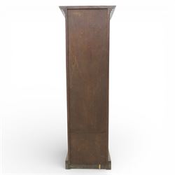 Edwardian oak pedestal office cabinet, moulded rectangular top over tambour shutter enclosing fitted interior, with fifteen graduated drawers each with recessed brass cup handle and label holders, panelled sides, on plinth base