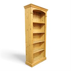 Traditional pine bookcase, projecting cornice with four fixed shelves (H 33cm, D 29cm), fluted sides, raised on a plinth base