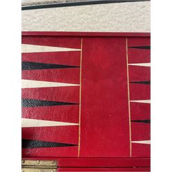19th century walnut and brass bound games compendium box, painted to enhance the grain, of rectangular form, the hinged opening cover with rounded sides, central brass cartouche with engraved lion crest, and brass riveted straps, opening to reveal a red leather and blue silk lined compartmented interior, with fold-down games board, and lift-out tray containing playing cards, ebony turned dice towers, white and red stained bone draughts, and chess pieces, ivory dice, and ivory and ebony whist markers, and brass bezique board, cribbage board and markers, H15cm W32cm D24cm
This lot has been registered for sale under Section 10 of the APHA Ivory Act
