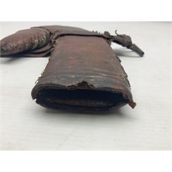 Eastern Jambiya, the 19cm double edge steel blade with raised medial ridge, waisted horn grip with pique work and white metal band; in stitched leather scabbard L33cm overall
