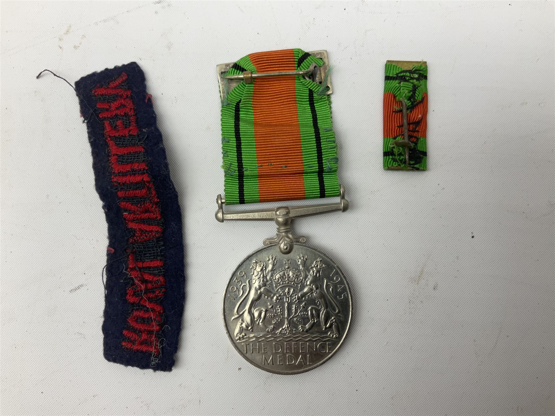 Royal Artillery 9ct gold and enamel sweetheart brooch in original box; together with Royal Artillery shoulder title, brass badges and buttons; and WW2 Defence Medal in issue box to 232775 addressed to Mrs. J.M. Morgan