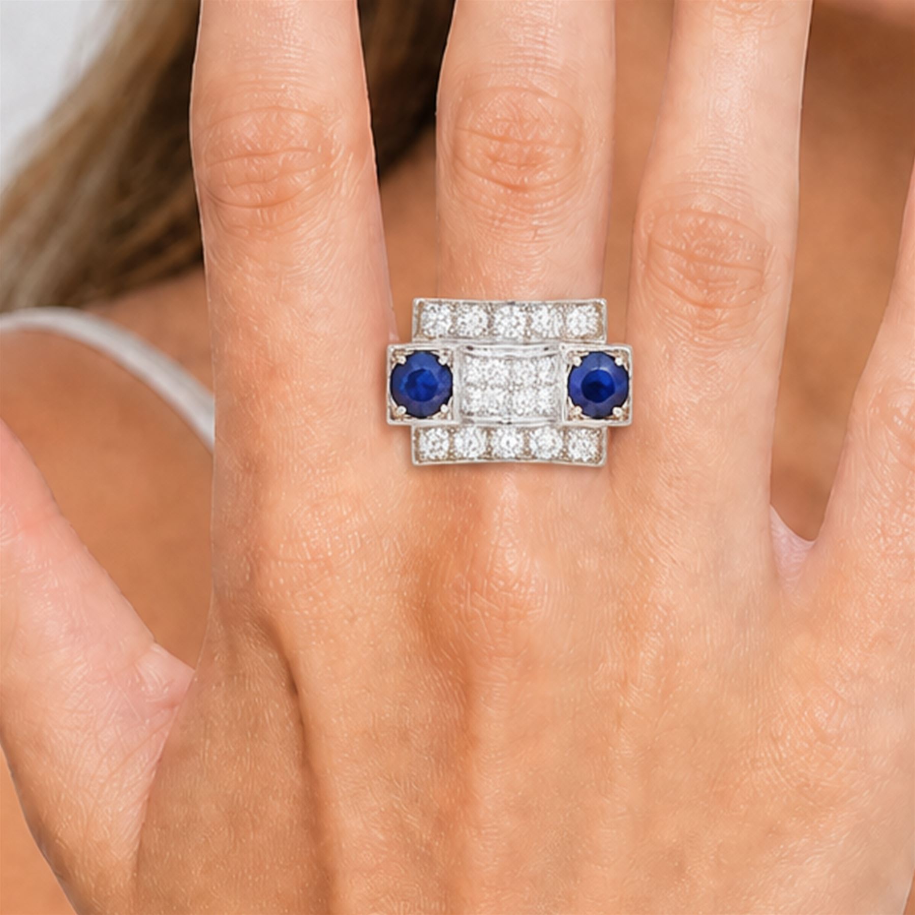 Platinum sapphire and diamond abstract design dress ring, pave set with eighteen old cut and round brilliant cut diamonds, with two mixed cut sapphires at each end, in a curved design setting, total sapphire weight approx 2.68 carat, total diamond weight approx 1.95 carat, with World Institute Report
