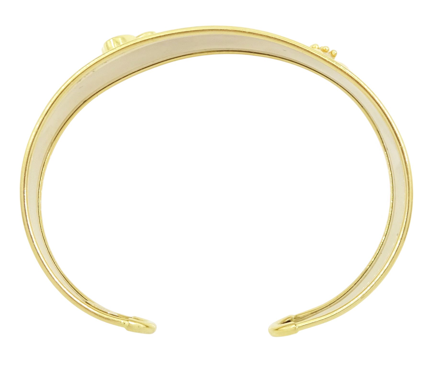 18ct gold 'Love' torque bangle, set with a heart cut pink sapphire and blue topaz, stamped Sidra 750