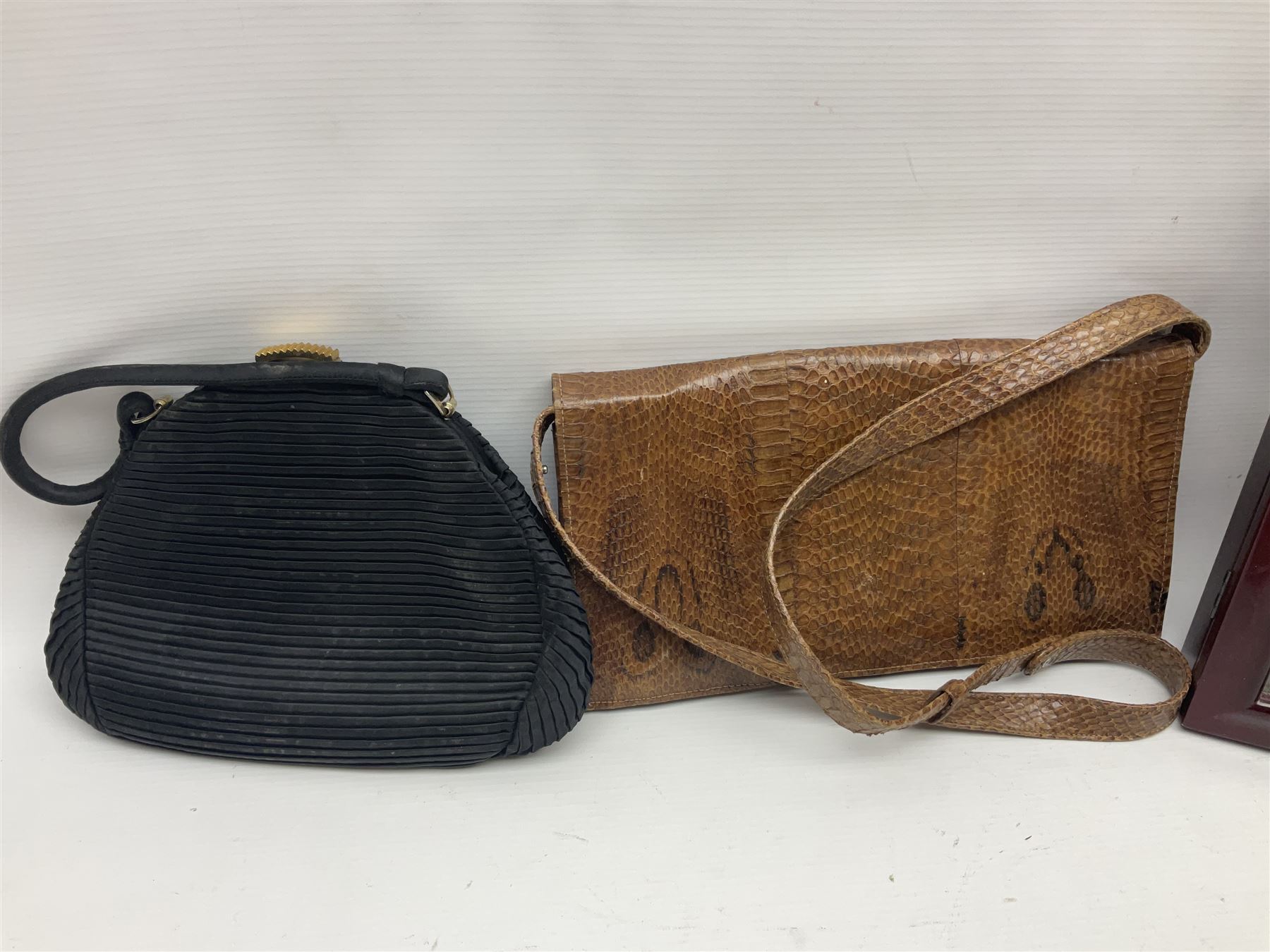 Continental petit point evening bag, with enamel and pearl details, in wooden display frame, together with a snake skin handbag and three other vintage bags