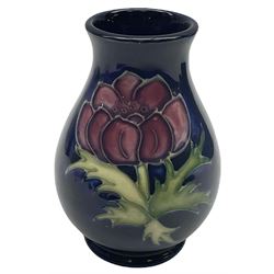 Two Moorcroft vases of baluster form, the first example decorated in the Clematis pattern, with paper label beneath, the second decorated in the Anemone pattern, with impressed marks beneath, including date symbol for 1993, each H10cm, each with maker's box.