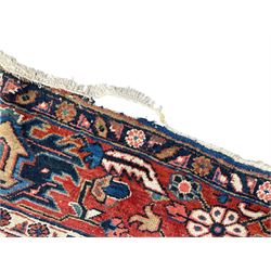 Persian blue ground carpet, the field divided up into panels by trailing bands with flower heads, each panel decorated with palmettes and stylised plant motifs, the border decorated with further palmettes, within floral pattern guard stripes 
