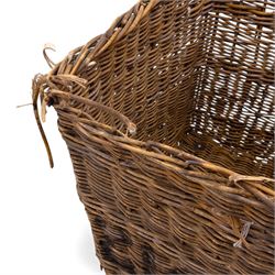 Large 20th century wicker laundry basket, of rectangular form, with stencilled lettering to one sides, raised on wooden base skids