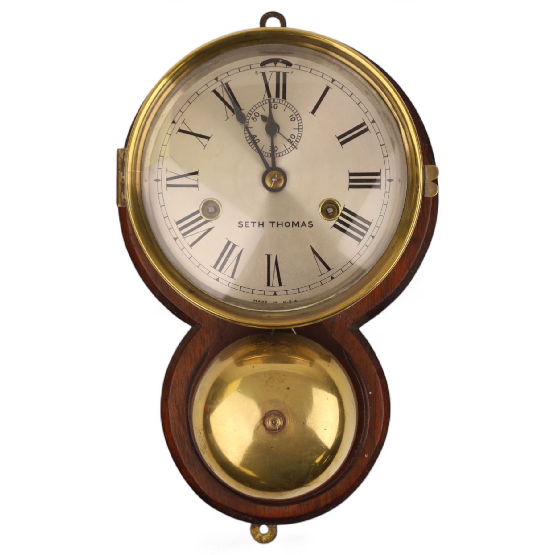 Seth Thomas U.S.A. Ships clock, circa1890, silvered dial with Roman numerals, steel spade hands and subsidiary seconds dial, with a circular alloy drum case mounted on a wooden plaque