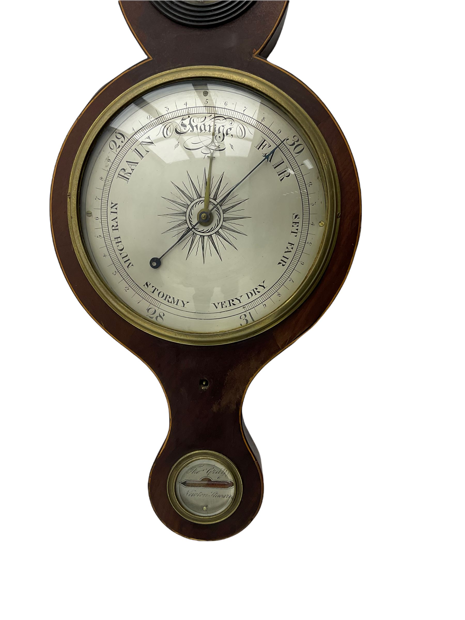 A mid Victorian mercury wheel barometer retailed by Thomas Grey of Newton Stewart, in a mahogany case with inlay to the edge, swans neck pediment and rounded base, with an 8” silvered register recording barometric air pressure from 28 to 31 inches with weather predictions, brass recording hand and steel indicating hand within a convex glass and cast brass bezel, silvered “butlers” mirror with reeded wooden surround and a round topped thermometer box with a mercury thermometer measuring degrees Fahrenheit, level bubble with silvered nameplate. H96cm
.


