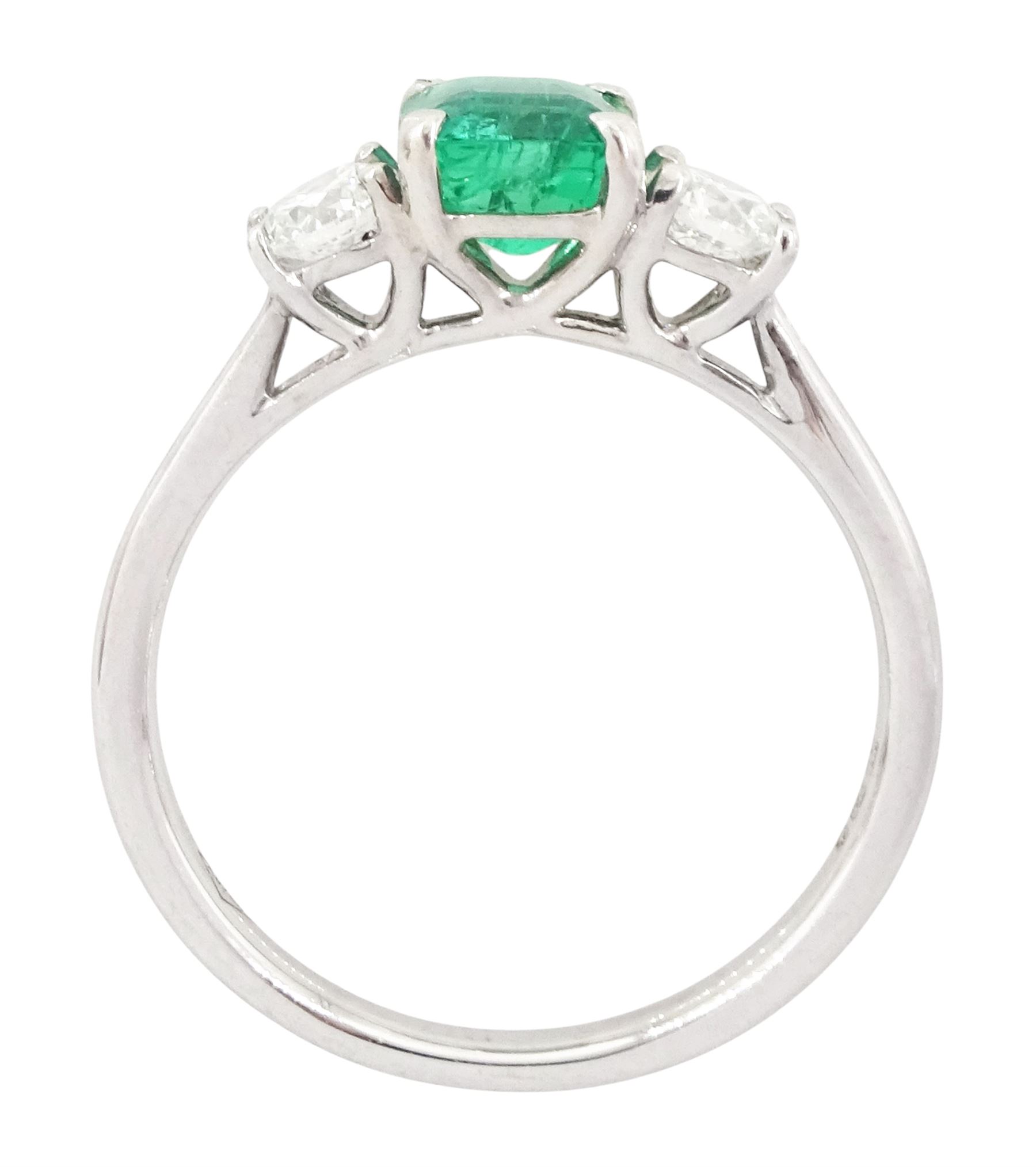 18ct white gold emerald and diamond three stone ring, single modified square cut emerald of approx 0.65 carat, with a round brilliant cut diamond set either side, hallmarked, total diamond weight approx 0.35 carat