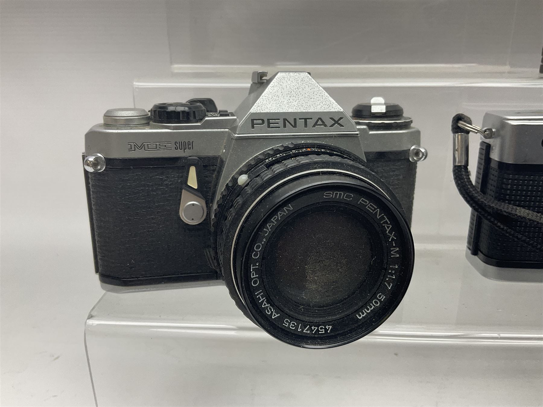 Olympus Pen-EE camera, serial no 415299, with Olympus D.Zuiko 1:3.5 f=2.8cm lens, together with four Olympus Trip 35 cameras, serial nos 4759245, 4257589, 1847727 and 5387611, each with Olympus D. Zuiko 1:28 f=40mm lenses