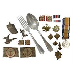  WW2 German Luftwaffe Mess cutlery comprising table spoon and fork, each with H.M.Z.38 mark; WW1 British War Medal awarded to L-13858 Gnr. J. McCabe R.A.; and small quantity of military badges, rank pips etc