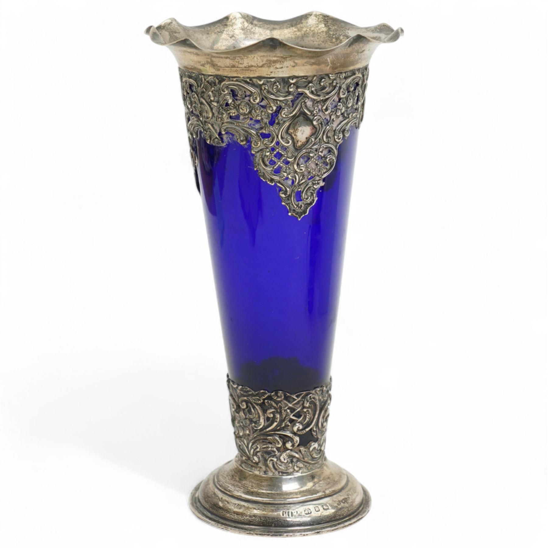 Late Victorian blue glass trumpet shape vase in pierced silver frame H20cm Birmingham 1899, modern blue glass globe scent flask with silver cover, two cranberry glass beakers in silver frames, cranberry sugar bowl in silver frame and blue glass sugar bowl with silver collar 