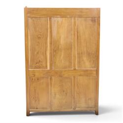 Rabbitman - oak glazed bookcase or display cabinet, lightly adzed rectangular top with raised gallery, twin glazed doors enclosing two shelves, over a pair of panelled cabinet doors with wrought iron fittings, with carved rabbit signature, by Peter Heap of Wetwang