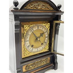 German Winterhalder and Hoffmeier quarter striking mantle clock in an ebonised arts and crafts case c1890, square brass dial with a matted centre, spandrels and silvered chapter ring, Roman numerals and Arabic five-minute numerals, half-hour markers and minute track, steel halberd hands within a glazed door, eight-day rack striking movement sounding the quarters and hours on two coiled gongs.


