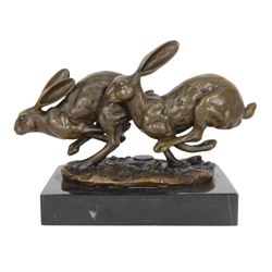 Bronze figure group, modelled as two hares in chase, signed Nick, with foundry mark, upon ...