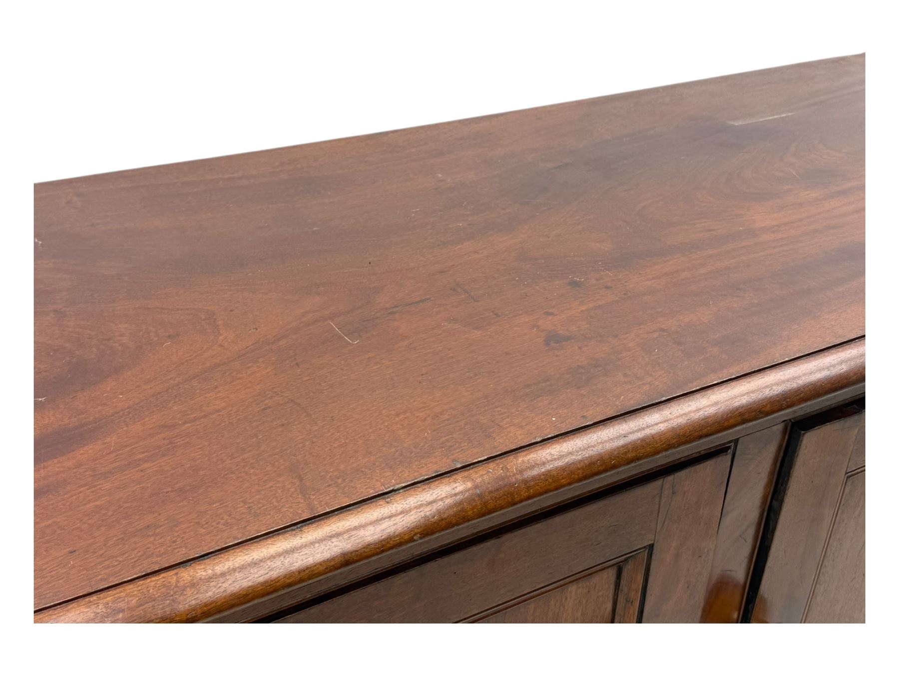 Victorian mahogany cupboard, plain rectangular top above two fielded panel doors opening to shelved interior, raised on a moulded plinth base, with later replacement knob handles