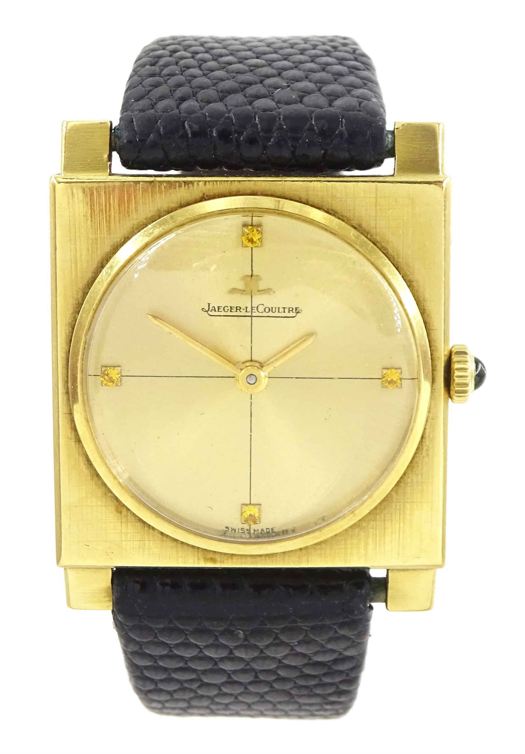 Jaeger LeCoultre gentleman's 18ct gold square cased manual wind wristwatch, champagne dial with yellow sapphire quarter markers, cabochon green sapphire crown, case No. 1109487, on black leather strap