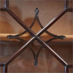 Large George III mahogany bookcase display cabinet, pierced swan neck pediment with floral head roundels over dentil and arcade frieze, enclosed by two geometric astragal glazed doors with lozenge motifs, the lined interior fitted with three shelves, gadrooned lower rail over acanthus carved cabriole supports with ball and claw feet 
