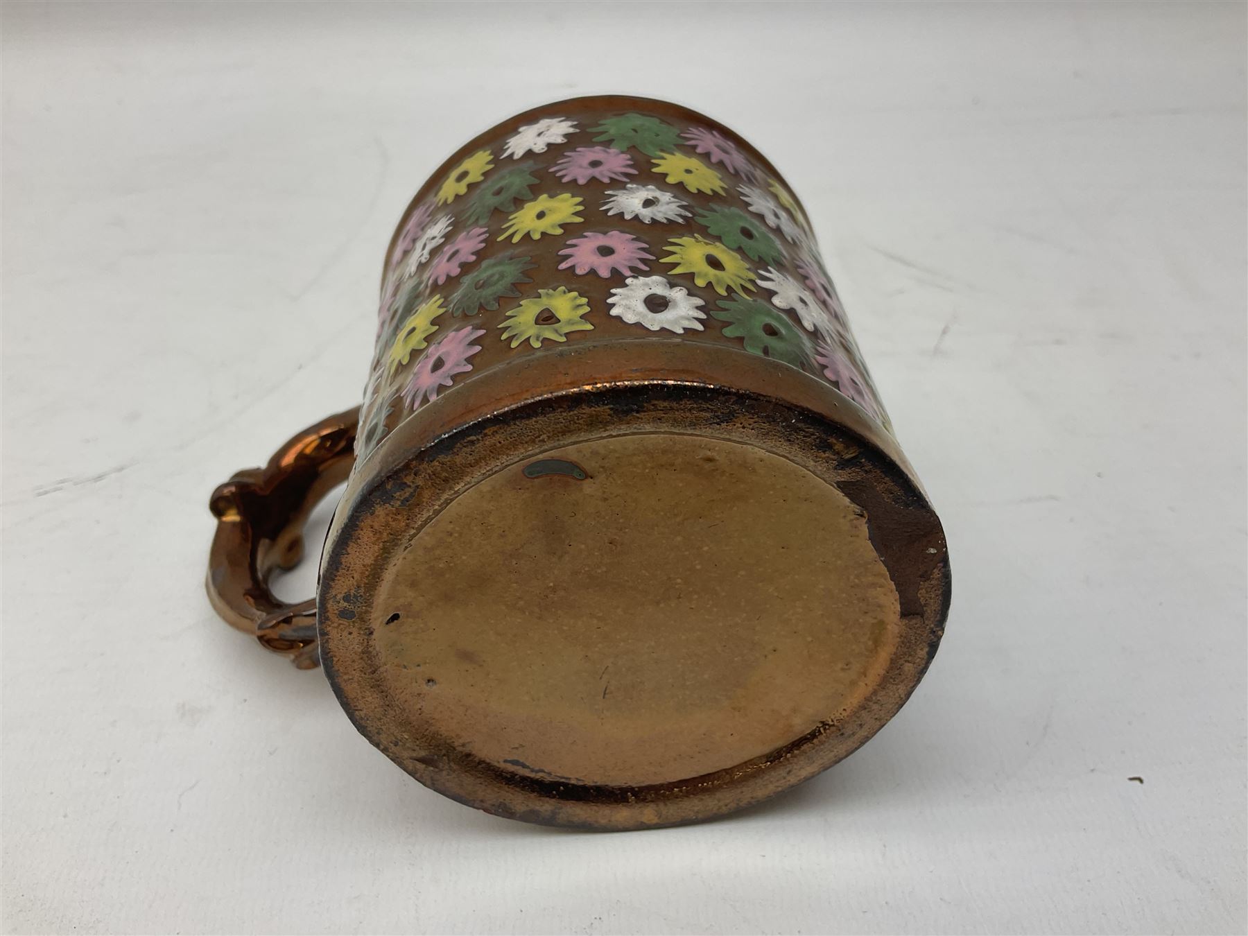 Five 19th century blue and white Delft tiles, each decorated with a central circular panel, containing buildings, boat, and swan, and a Victorian lustre mug decorated with polychrome flowers, tiles H13cm W13cm. 