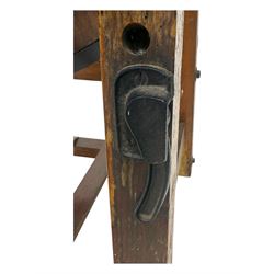 19th century oak and cast iron rotary butter churn, with coopered barrel body, domed lid with filler opening and cast iron securing arms, on tilting iron-mounted frame with crank handle and support rails