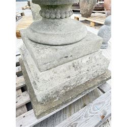 Pair of large weathered Country House Haddonstone garden urns, acanthus carved rim above gadrooned bowl, beaded detailing to the neck, raised on stepped double plinth base
