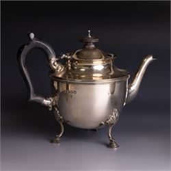 Early 20th century silver three piece bachelor's tea service, comprising teapot, open sucrier and milk jug, all of circular waisted form with shaped rims and upon three stepped feet, the teapot with ebonised wooden handle and finial, hallmarked Wakely & Wheeler, London 1914, teapot height H15cm