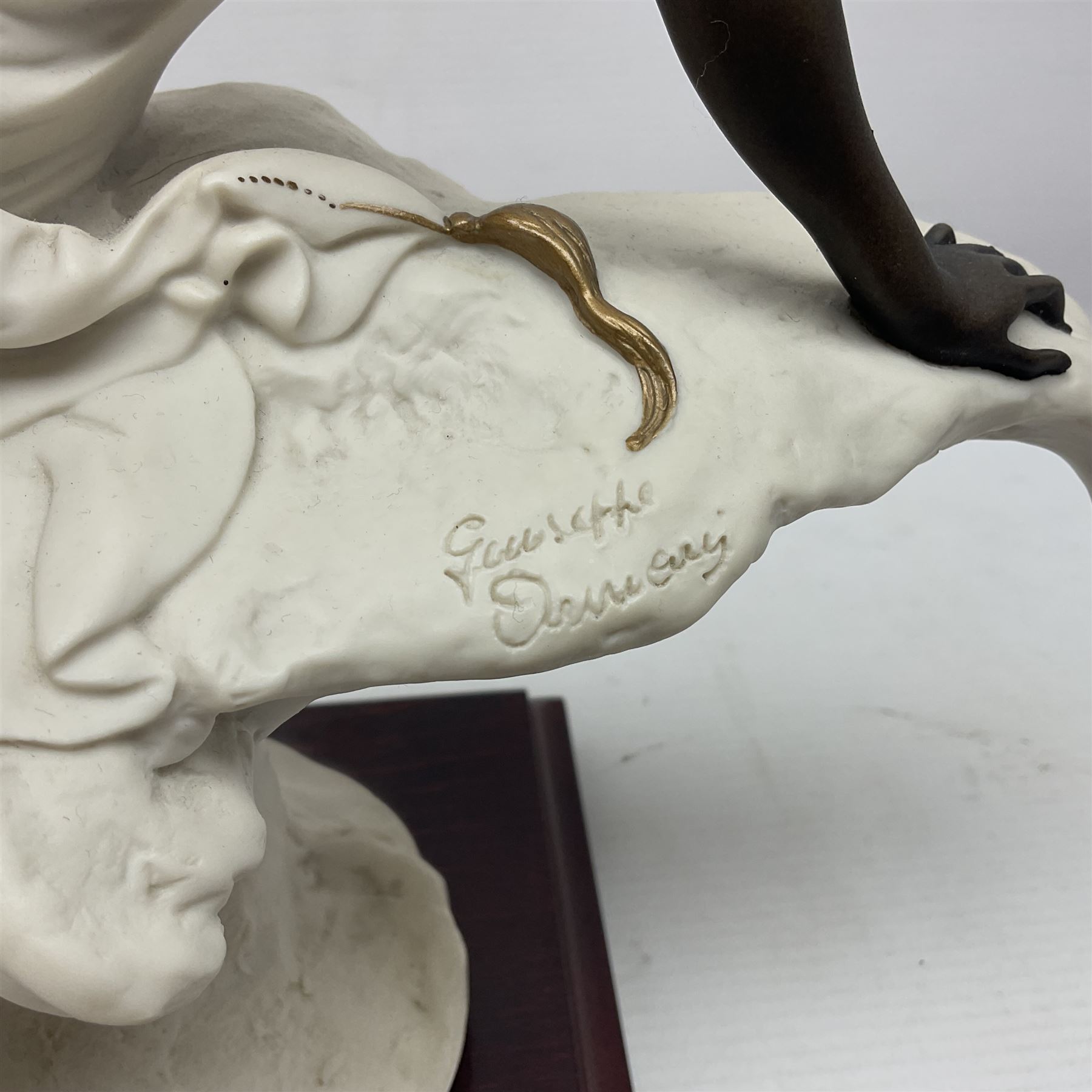 Giuseppe Armani Florence figure, Black Maternity, modelled as a mother and child upon a stylised cloud and mahogany base, H32cm