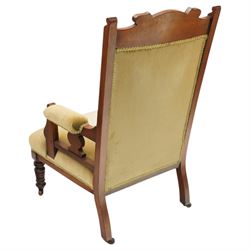 Pair of late Victorian mahogany carved open armchairs, with carved cresting rail, above upholstered seat, back and arms, raised on turned supports terminating in castors