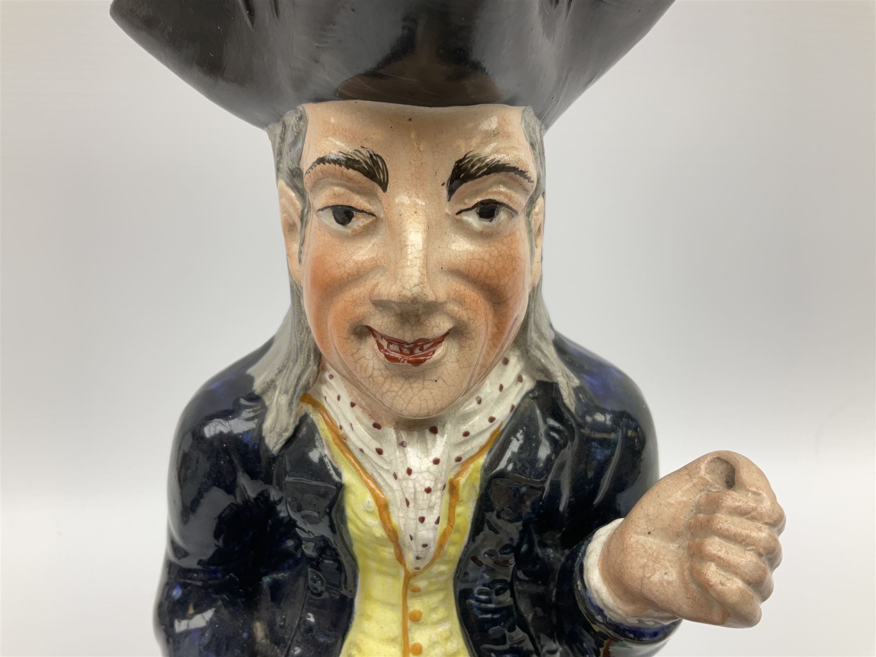 Early 20th century Staffordshire William Kent Squire toby jug, modelled seated upon a corner chair holding a jug of ale in his right hand, H28cm