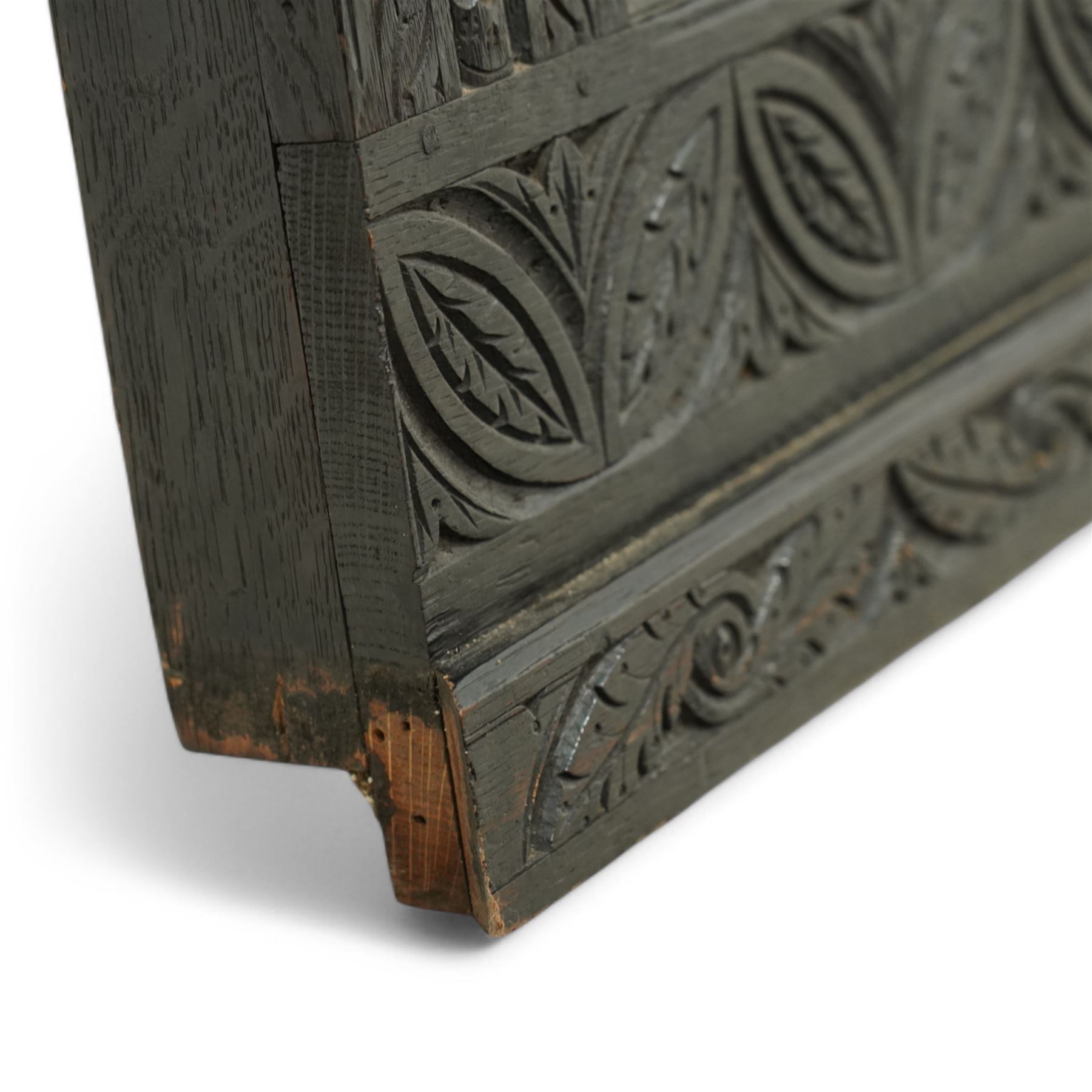 Victorian heavily carved oak wall mirror, lunette and foliage carved frieze over central bevelled mirror and flanking panels carved with floral urns, the upright frame decorated with geometric pattern chip carvings, lunette carved lower rail 