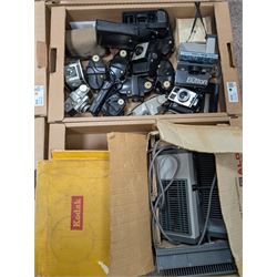 Collection of vintage cameras, projectors and accessories, including Kodak Brownies, Praktica, Polaroid, Ensign, light meters, flashes, etc