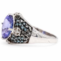 9ct white gold tanzanite and diamond ring, single oval cut tanzanite of approx 1.70 carat, surrounded by four single cut white diamonds and pave set blue diamonds, hallmarked