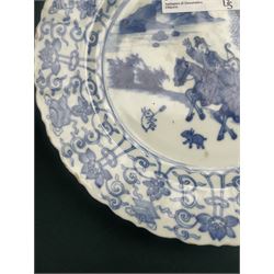 Chinese Kangxi style blue and white plate, decorated to the centre with a hunting scene  of two hunters on horse back, surrounded by a foliate boarder, with with six character double ring mark beneath