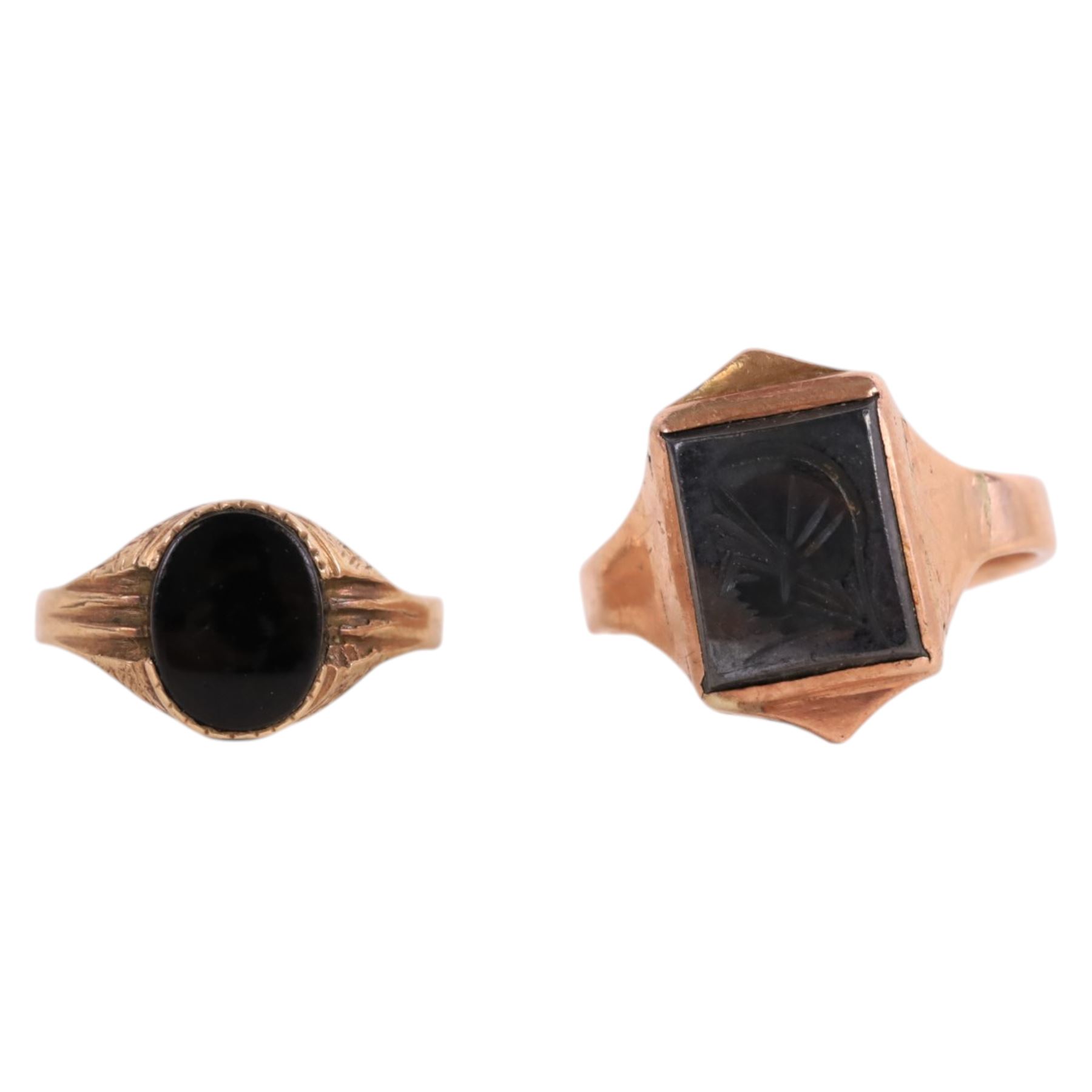 Two 9ct gold signet rings, comprising haematite example with carved warrior head and black onyx example