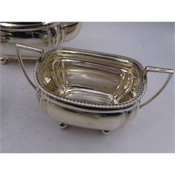 1920s silver three piece bachelors tea service, comprising teapot, cream jug and twin handled open sucrier, each of bellied form with oblique gadrooned rim, upon four bun feet, the teapot with Bakelite type handle and finial, hallmarked Thomas Edward Atkins, Birmingham 1912, teapot H13.5cm